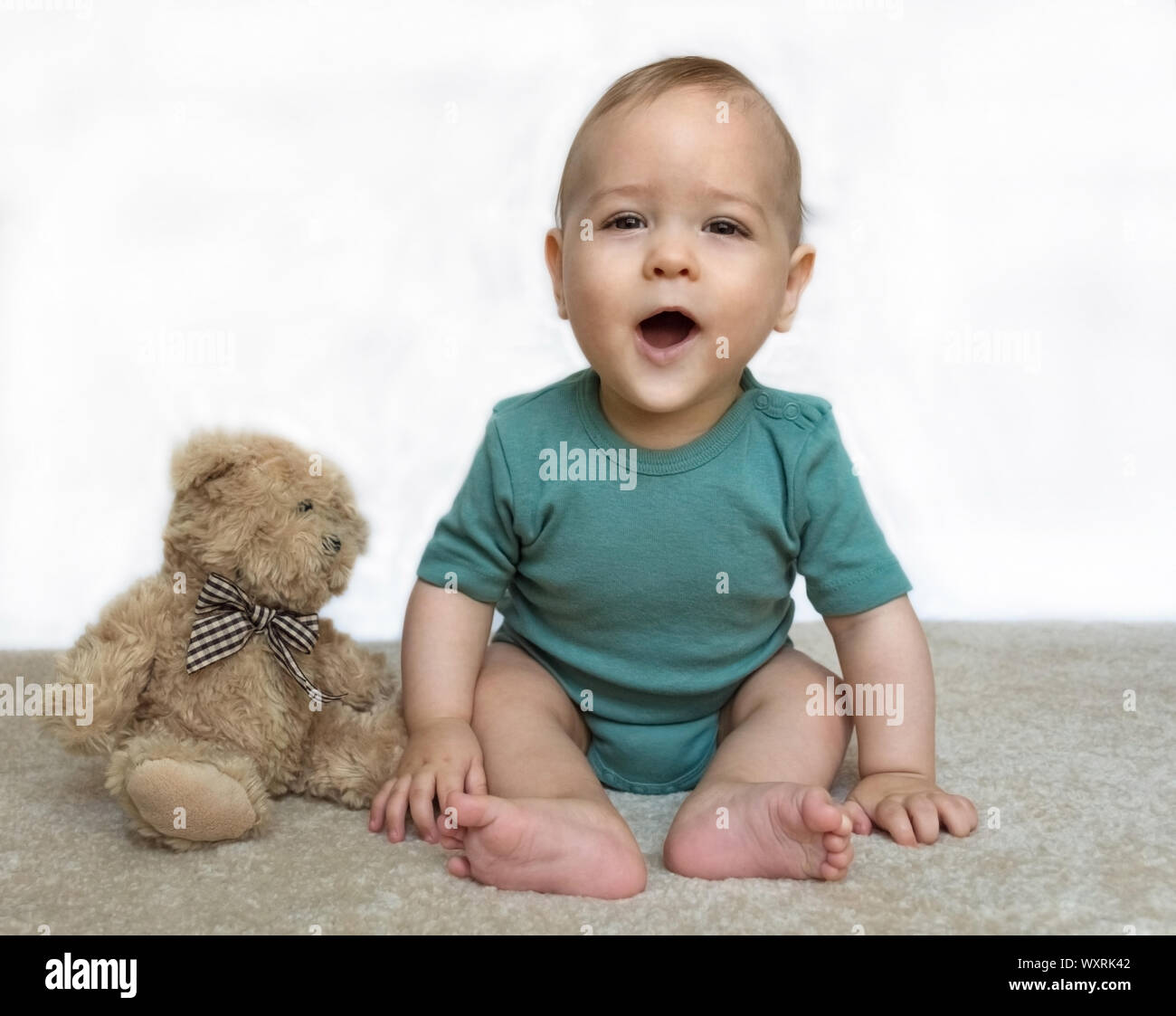Sweet little baby boy with teddy bear on white background Stock Photo ...