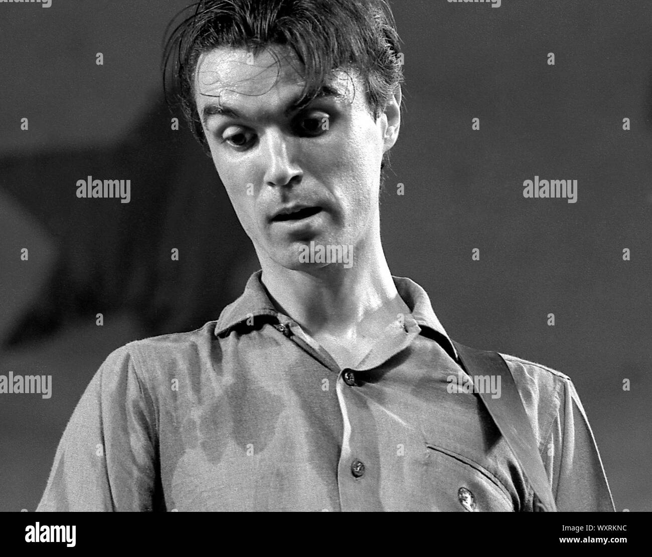 David Byrne of the music group Talking Heads performs onstage in Central Park in New York City in August, 1979. Stock Photo