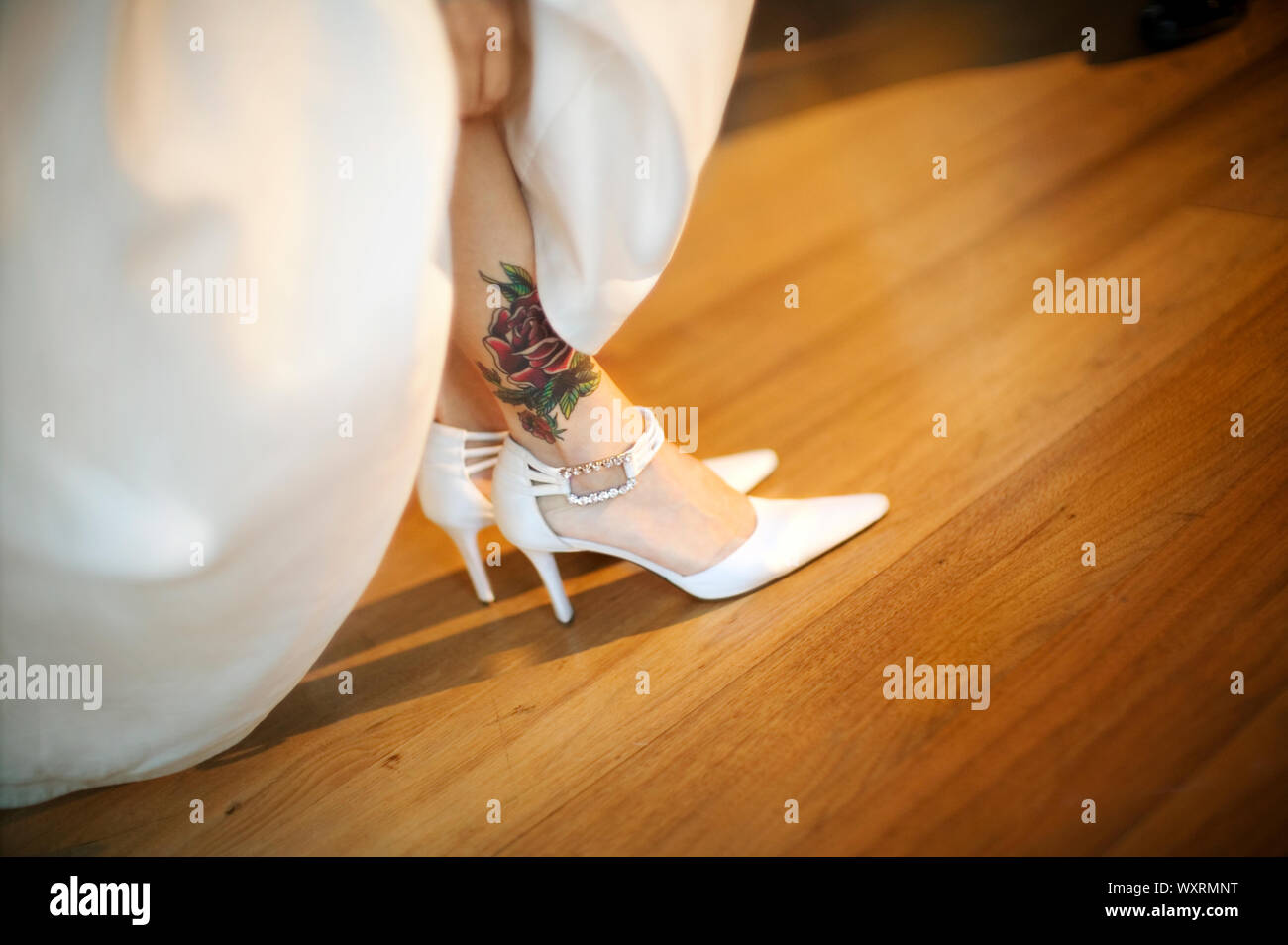 Rose tattoo and white pointed high heels Stock Photo Alamy
