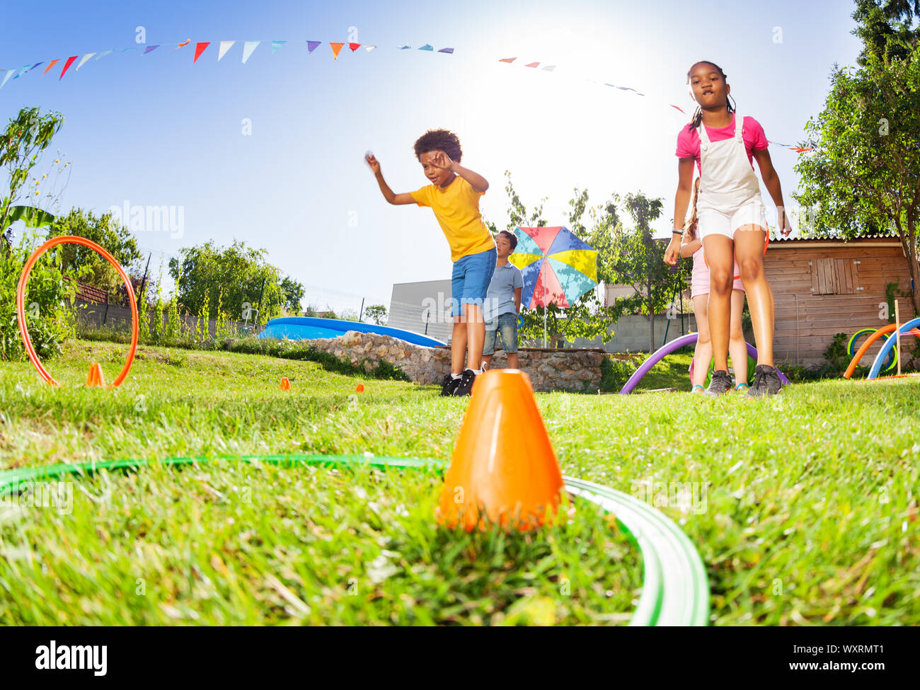 Boy and girl throw hula hoops rings totarget Stock Photo Alamy