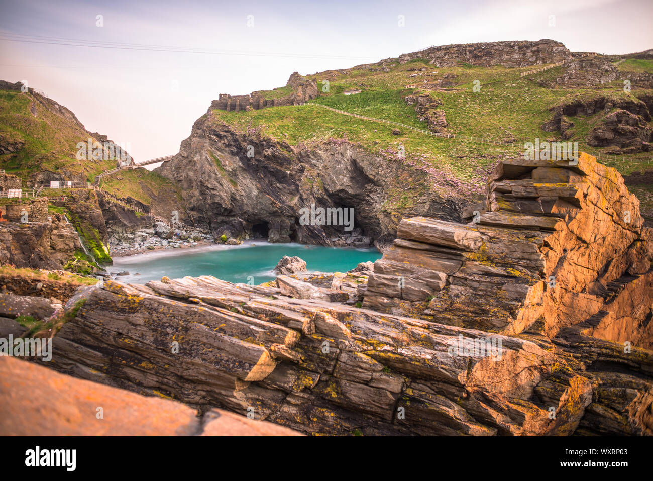 The ruins of Tintagel Castle on Tintagel Island at sunset, a site linked with the legend of King Arthur, Cornwall, England, UK Stock Photo