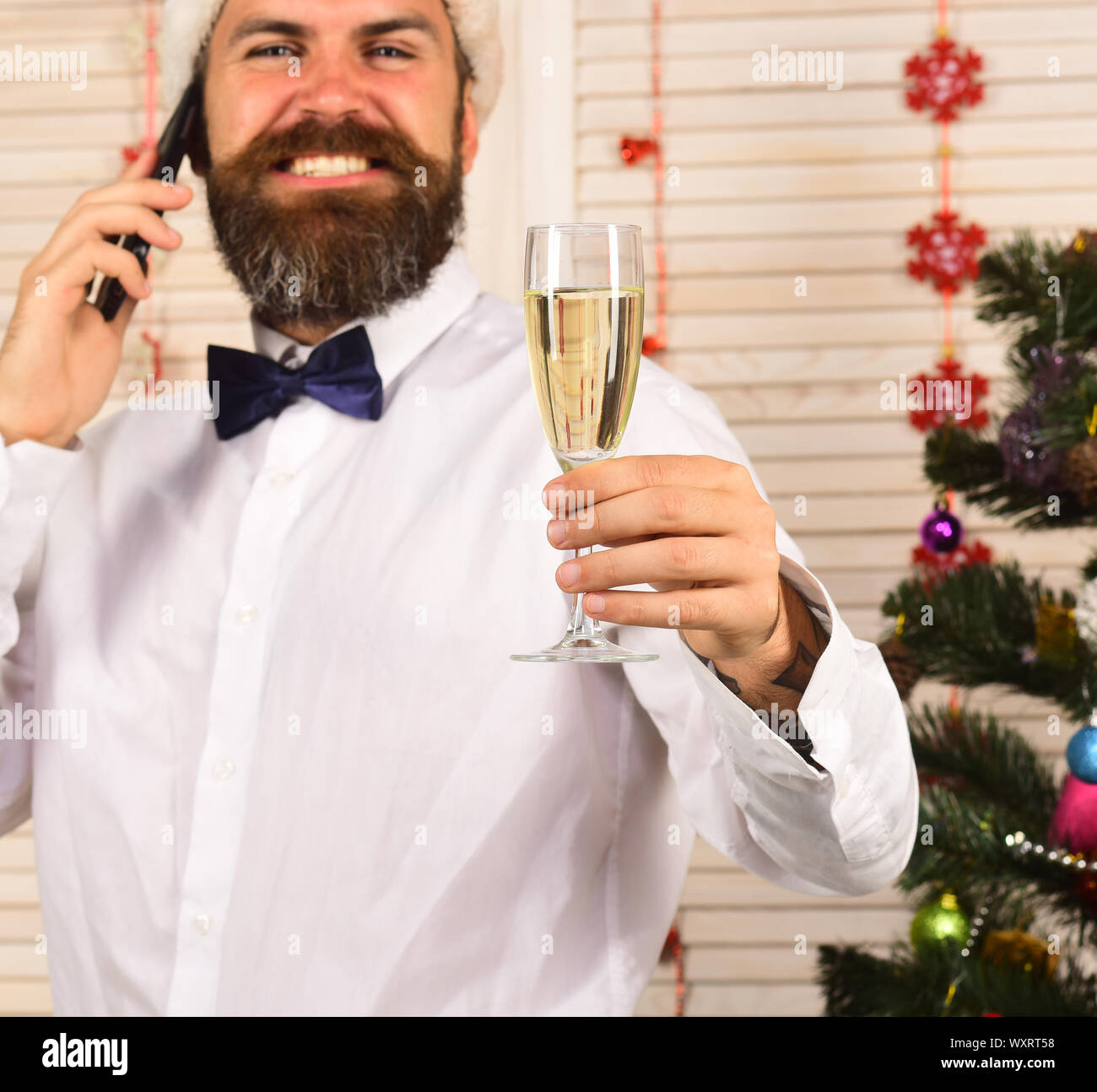 Celebration and New Year greetings concept. Guy near Christmas tree and ...