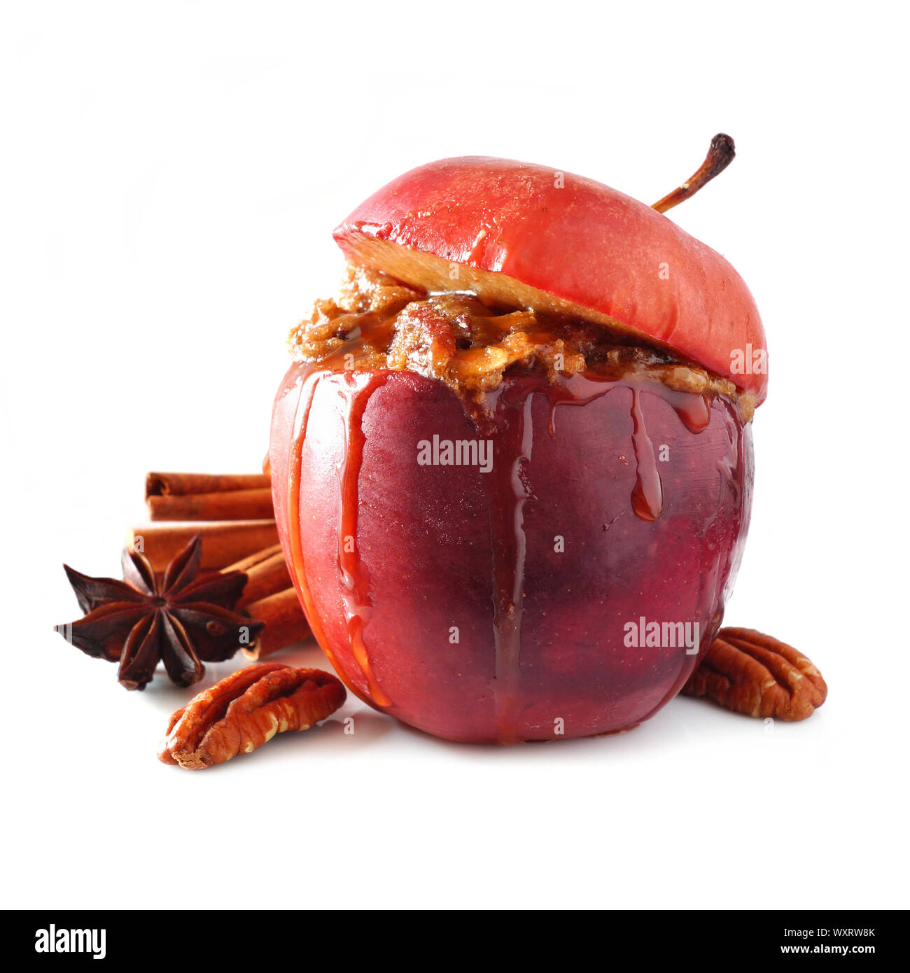 Baked apple with caramel, brown sugar, spices and and nuts isolated on a white background Stock Photo