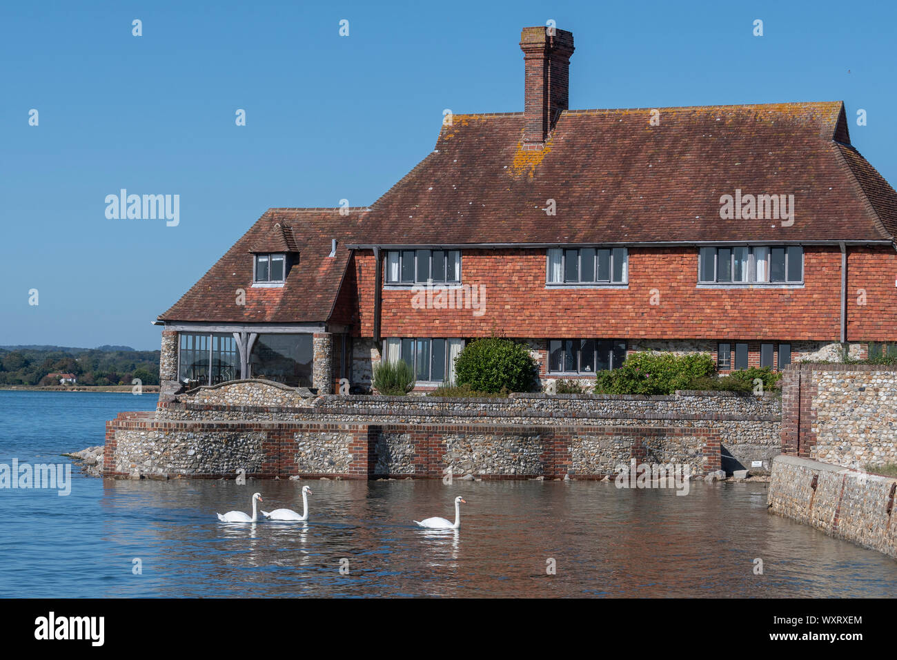Typical West Sussex house on the edge of the water in the picturesque  harbour village of Bosham, Chichester Harbour, West Sussex, England, UK Stock Photo