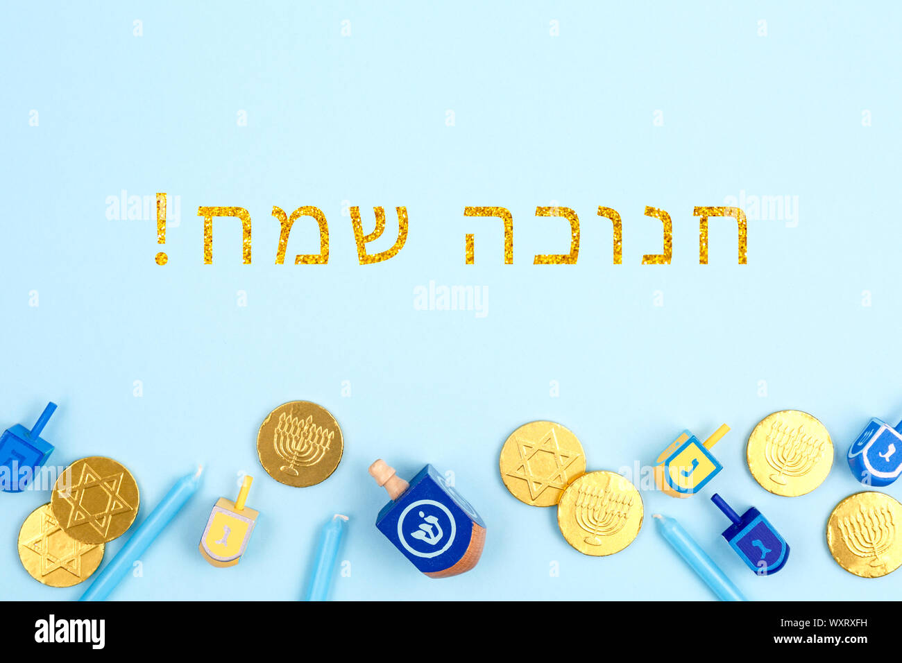 Blue backdrop with dreidels, menora candles and chocolate coins with ...