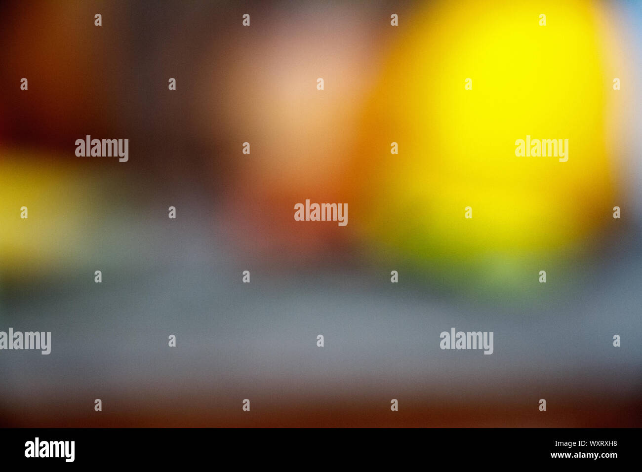 Abstract defocused round shaped orange and yellow lights on a dark backdrop Stock Photo