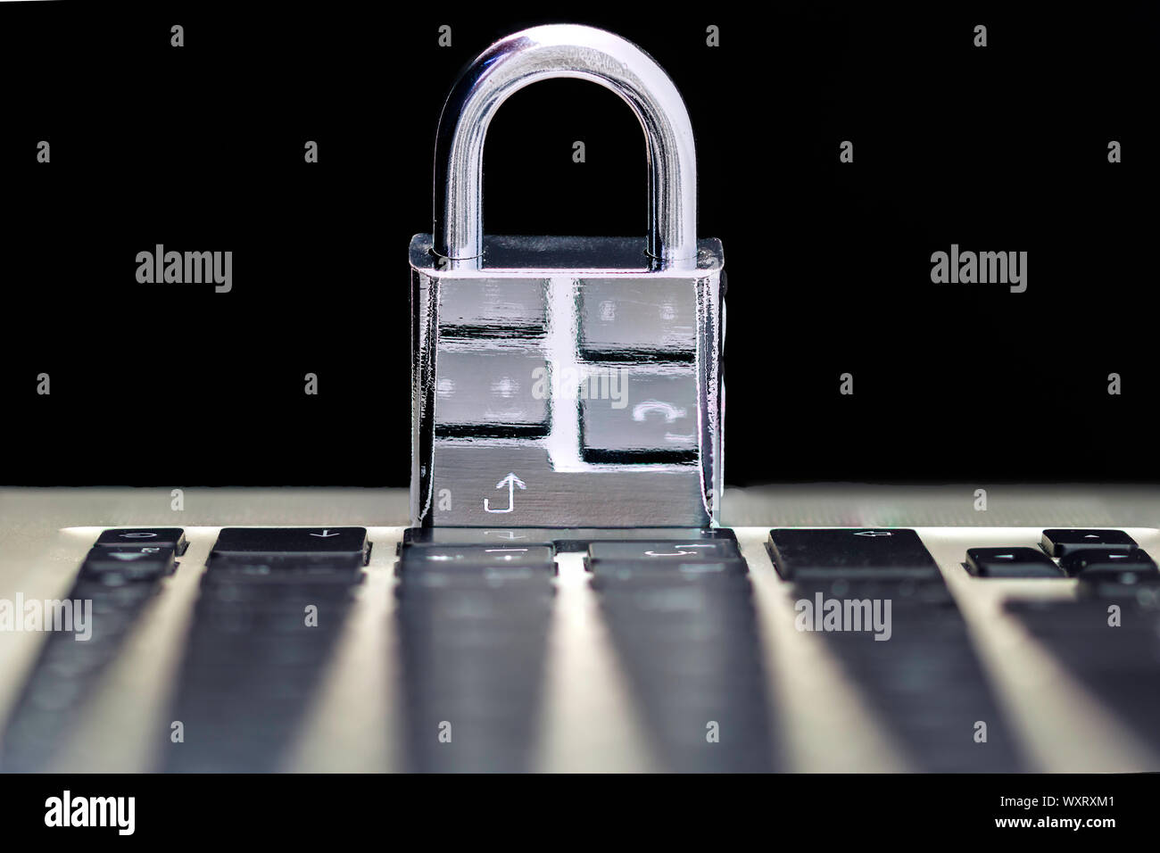 Computer Security Concept with a Closed Padlock on the Keyboard on Black Background Stock Photo
