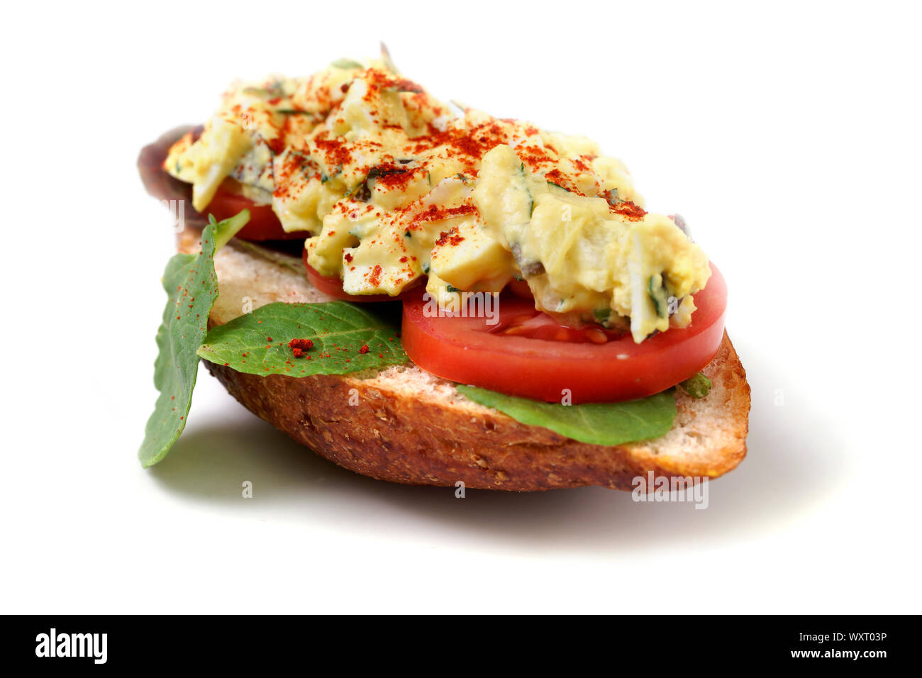 Close-up photograph of delicious open face egg salad sandwiches with tomato and lettuce. Stock Photo