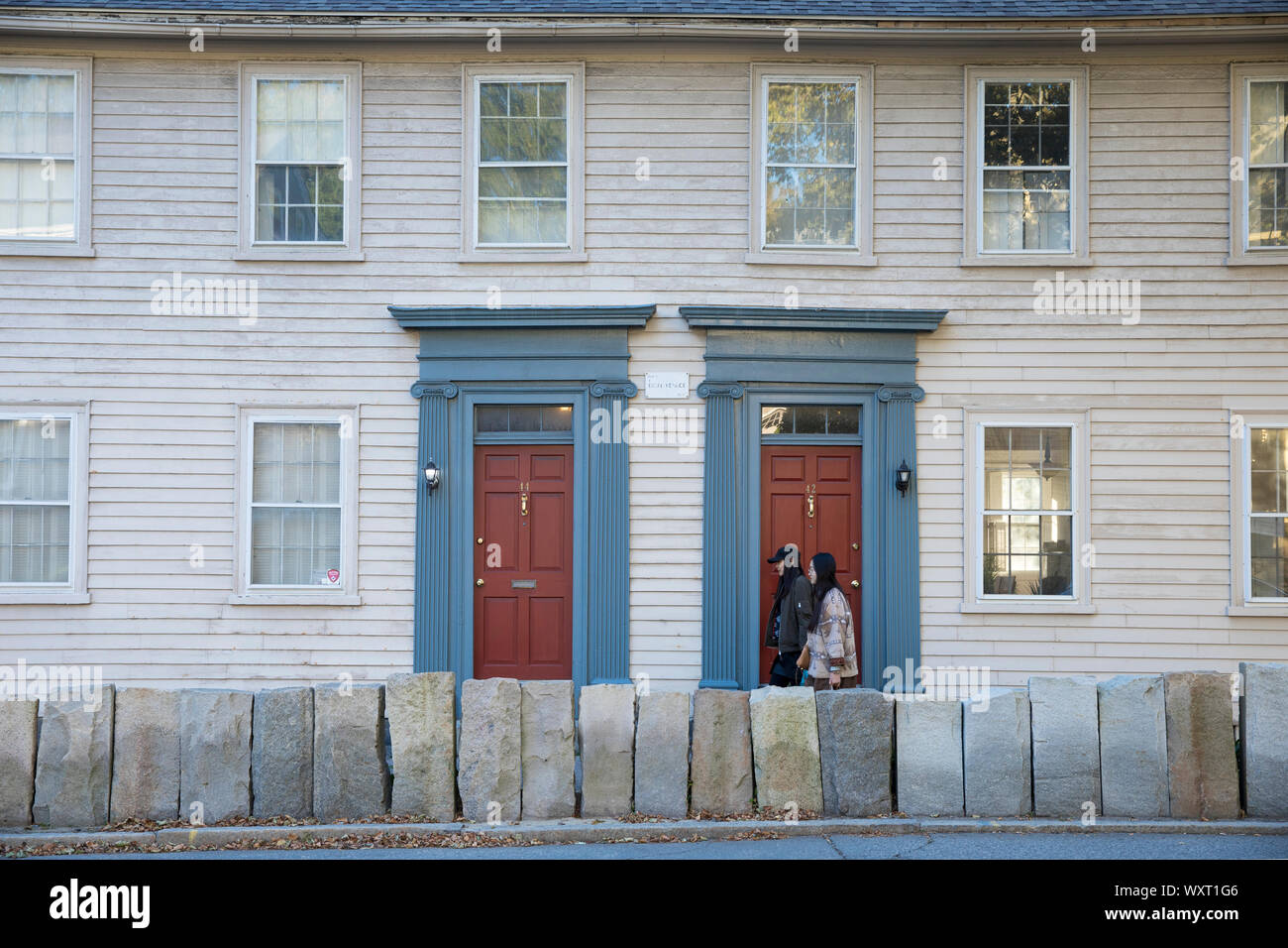 Locals walking past wooden clapboard elegant period houses on Benefit