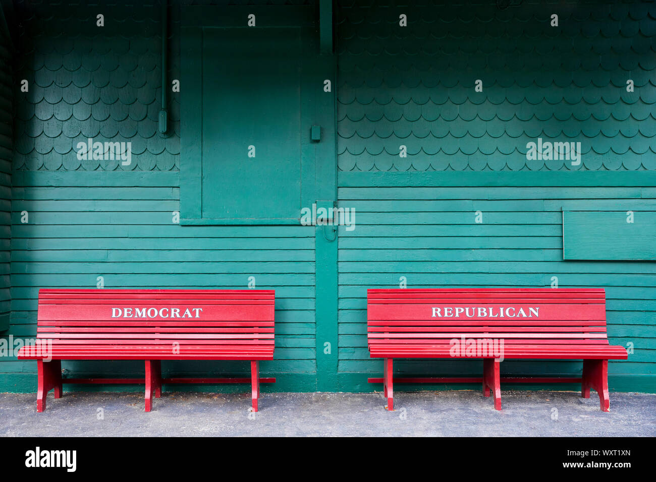 Segregated benches for Democrat and Republican at Pride's Crossing former railroad crossing in Massachusetts, USA Stock Photo