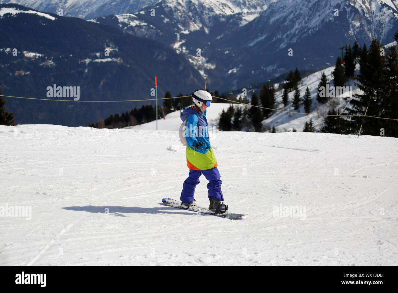 Woman snowboarder on ski piste on a sunny day at Chamonix of Megeve, France  Stock Photo - Alamy