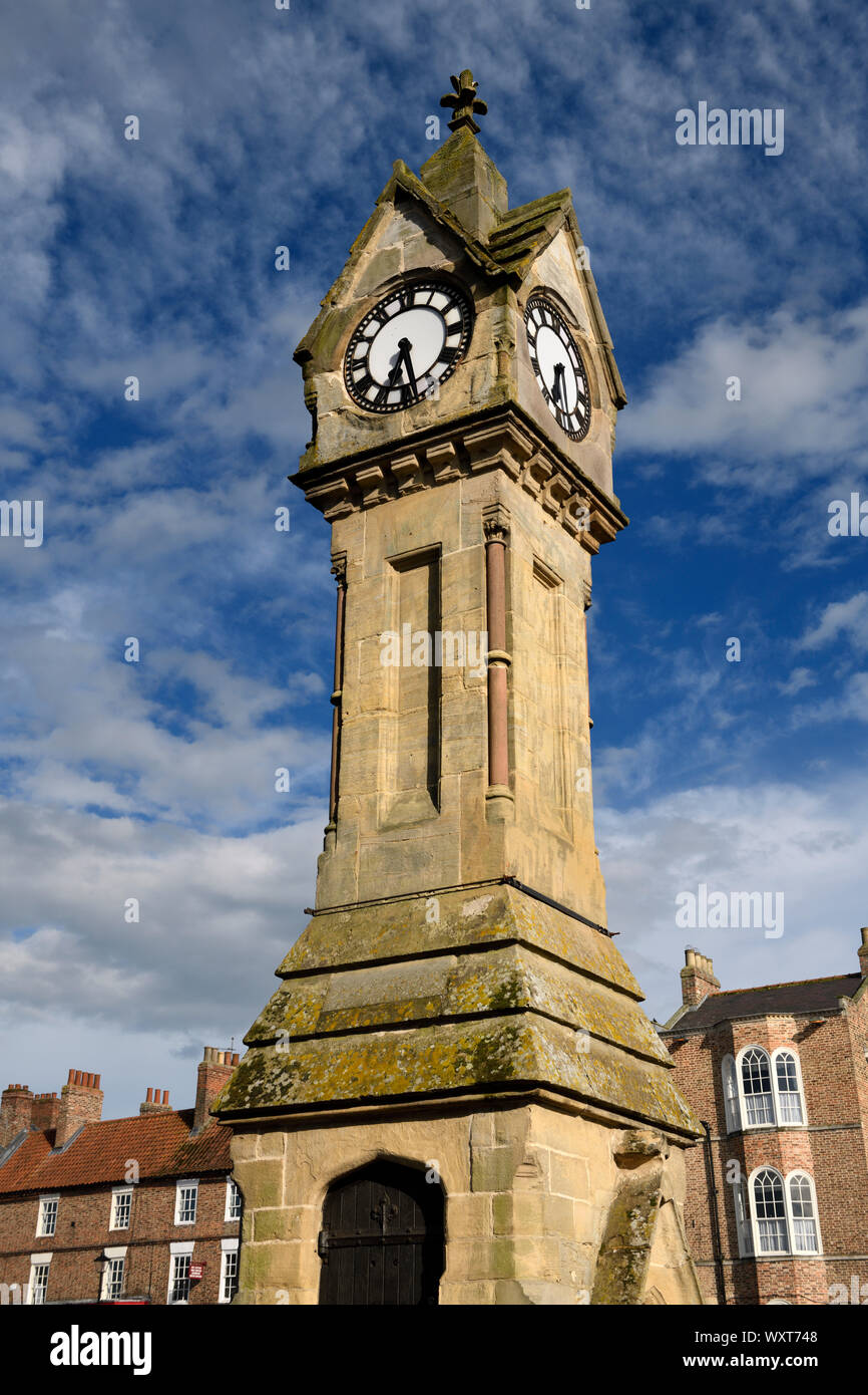Evening light on Clock tower made of yellow Cotswold limestone in the Town Centre of Thirsk Market town North Yorkshire England Stock Photo