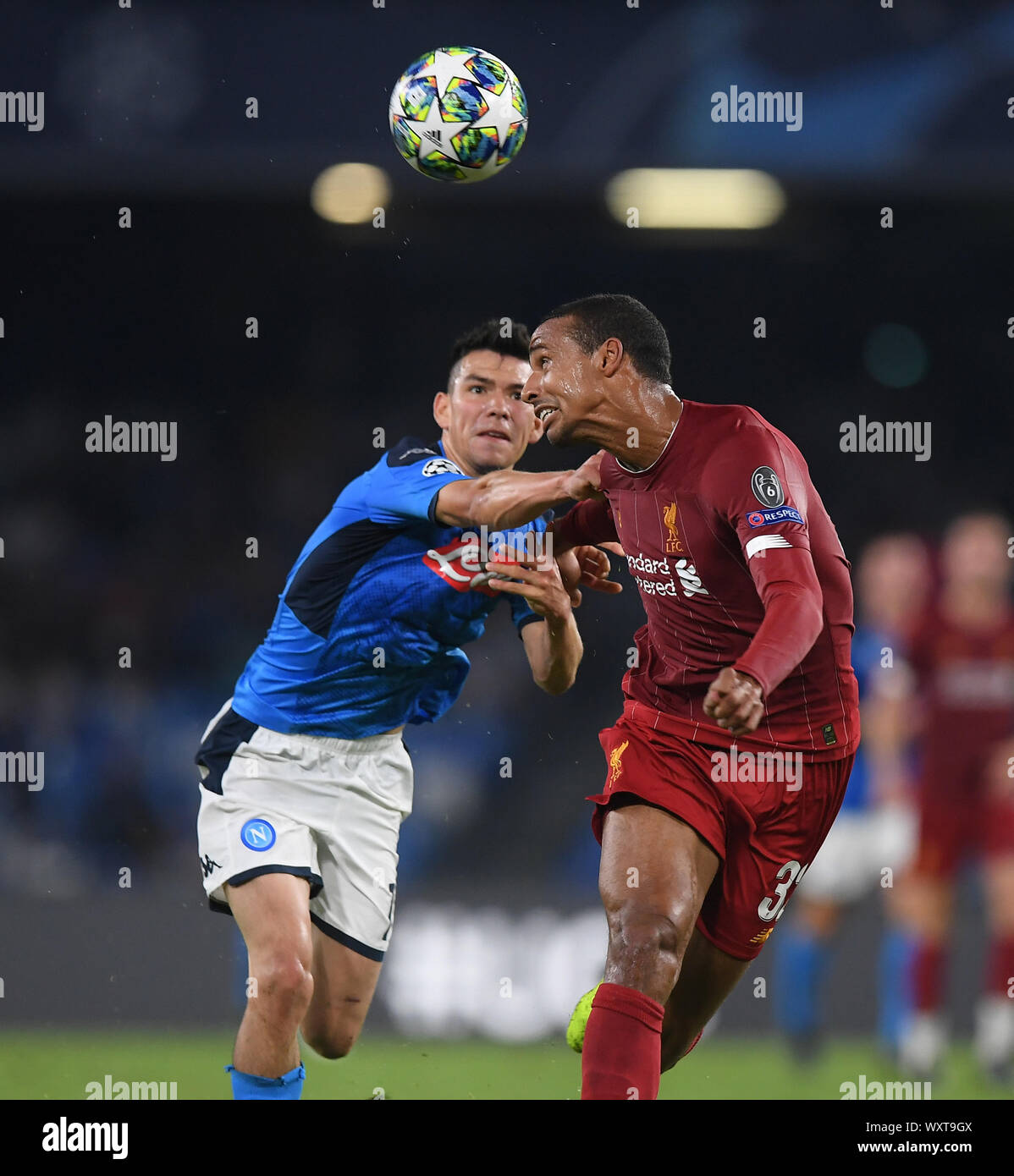 Napoli. 17th Sep, 2019. Napoli's Hirving Lozano (L) vies with Liverpool's Joel Matip during the UEFA Champions League Group E match in Napoli, Italy, Sept.17, 2019. Credit: Alberto Lingria/Xinhua/Alamy Live News Stock Photo