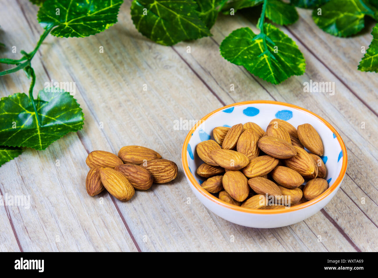 Almonds in a Bowl on a Wooden Background Stock Photo