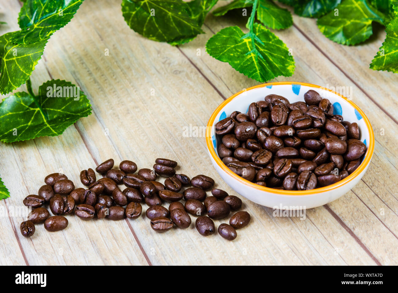 Coffee Beans in a Bowl on a Wooden Background Stock Photo
