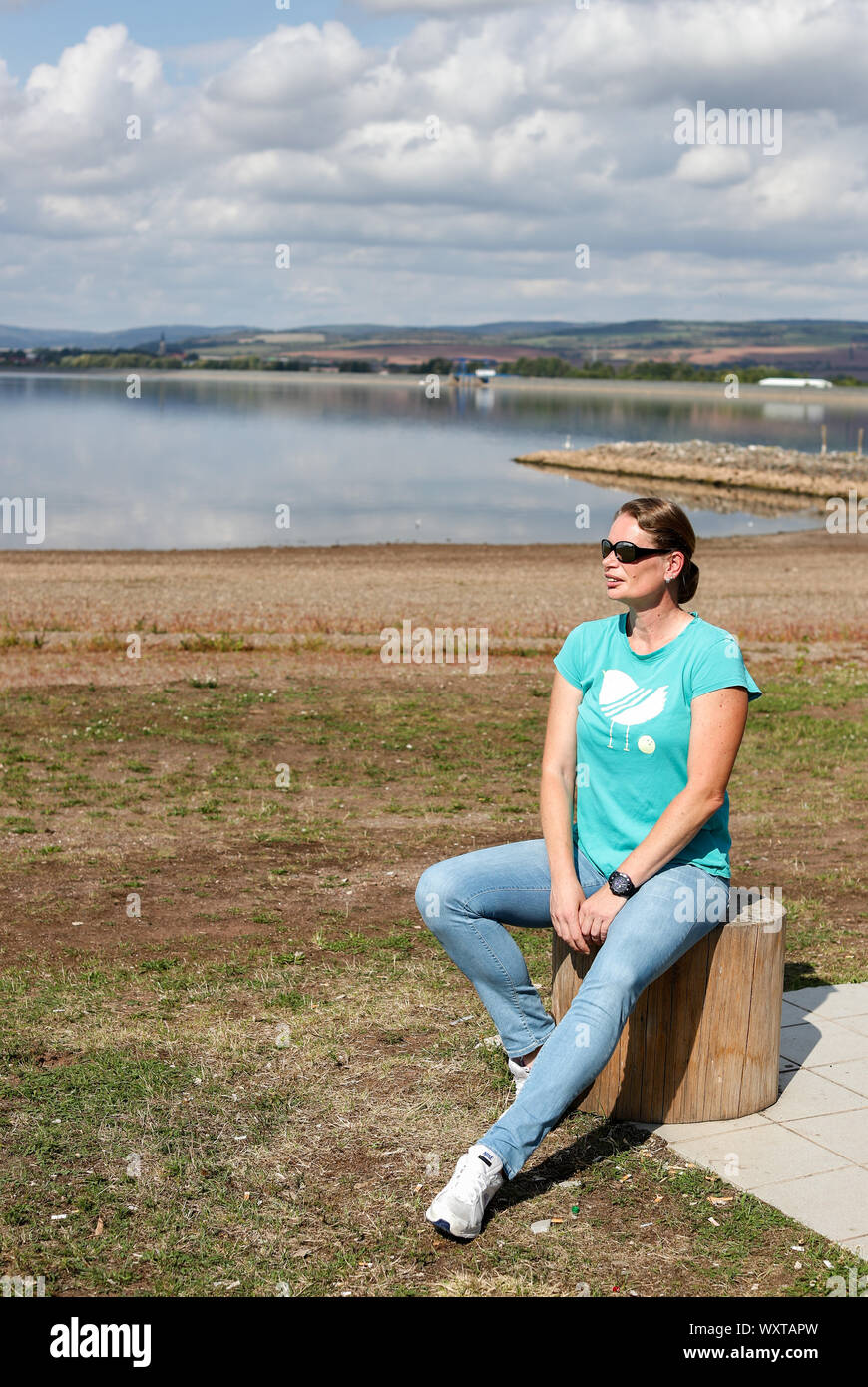 12 September 2019, Saxony-Anhalt, Kelbra: Former shot-putter Nadine Kleinert walks along the Kelbra reservoir. Lack of attractiveness for teenagers, hardly any TV presence, frustrated coaches and the often lacking financial security of the athletes: The former world-class shot-putter does not give the Olympic core sport a great future. 'If things continue like this, athletics will be dead in ten years - and the DLV will no longer exist,' said the 2004 Olympic silver medallist in an interview with the German Press Agency. (to dpa 'Ex-ball-putter Kleinert: 'This is no longer my athletics!') ») P Stock Photo