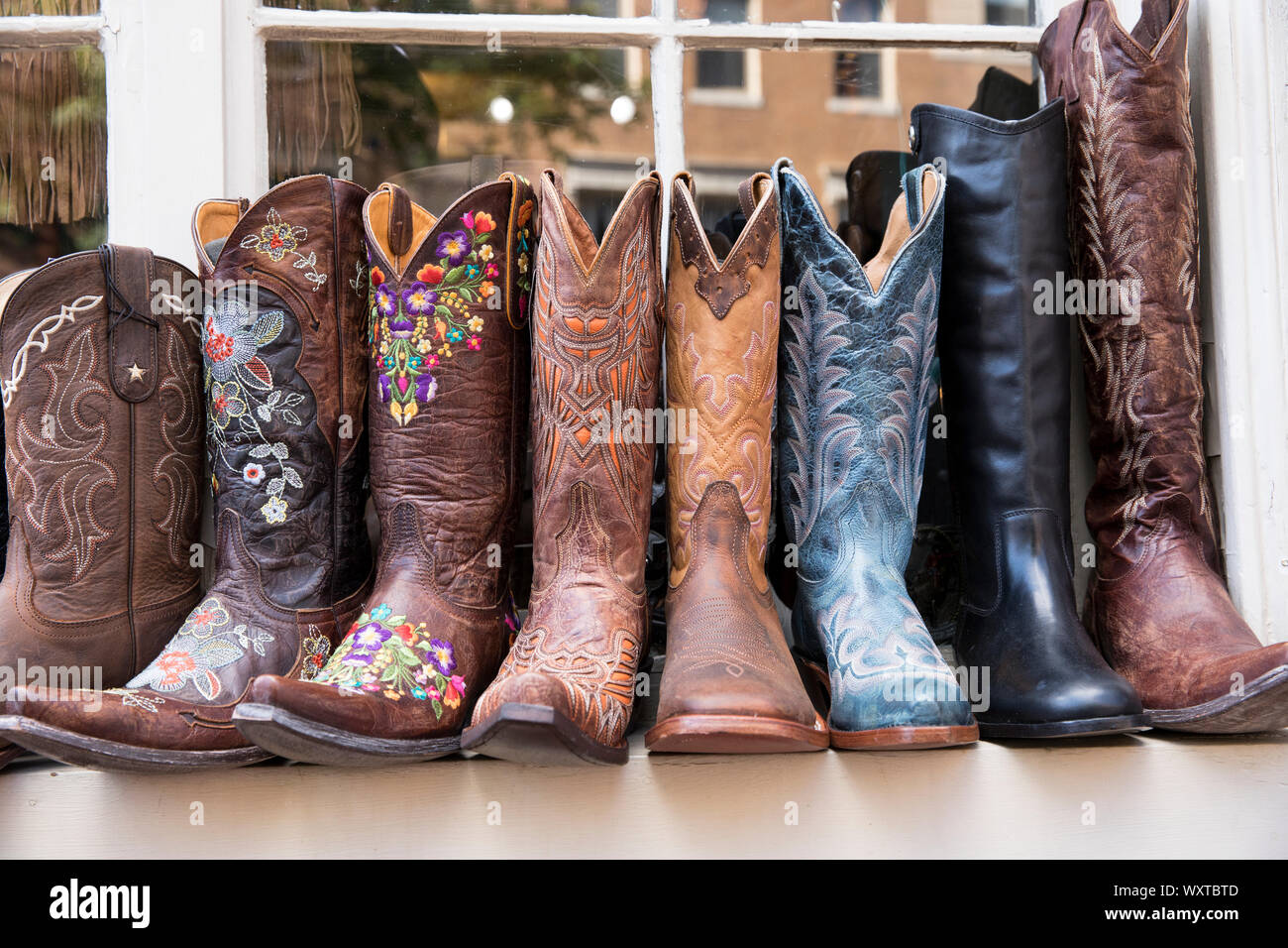 Typical leather cowboy boots on sale in shop in Charles Street in the historic district of Boston, Massachusetts, USA Stock Photo