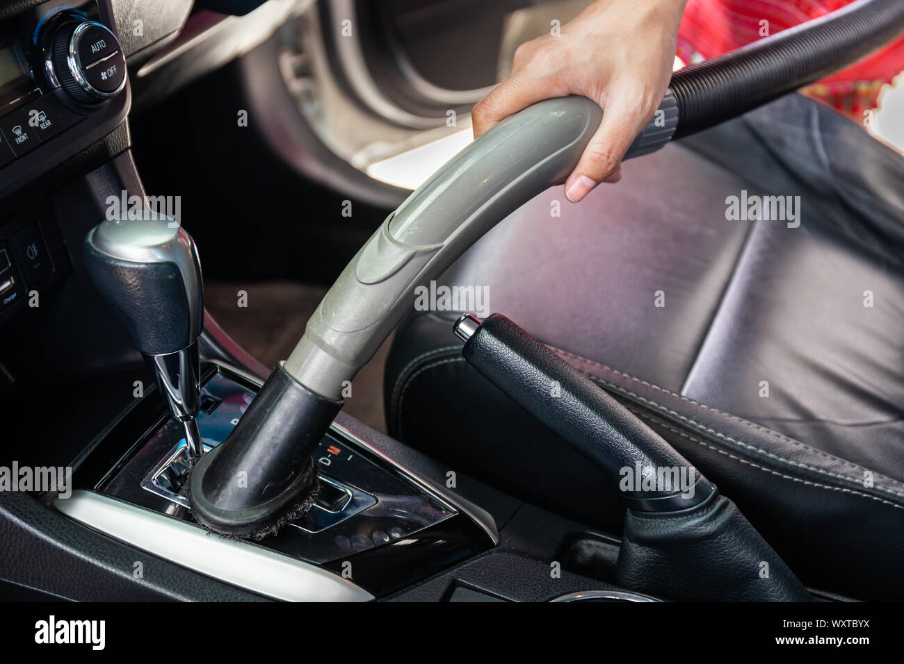 Cleaning modern car interior with vacuum cleaner. Handle vacuum Stock Photo Alamy
