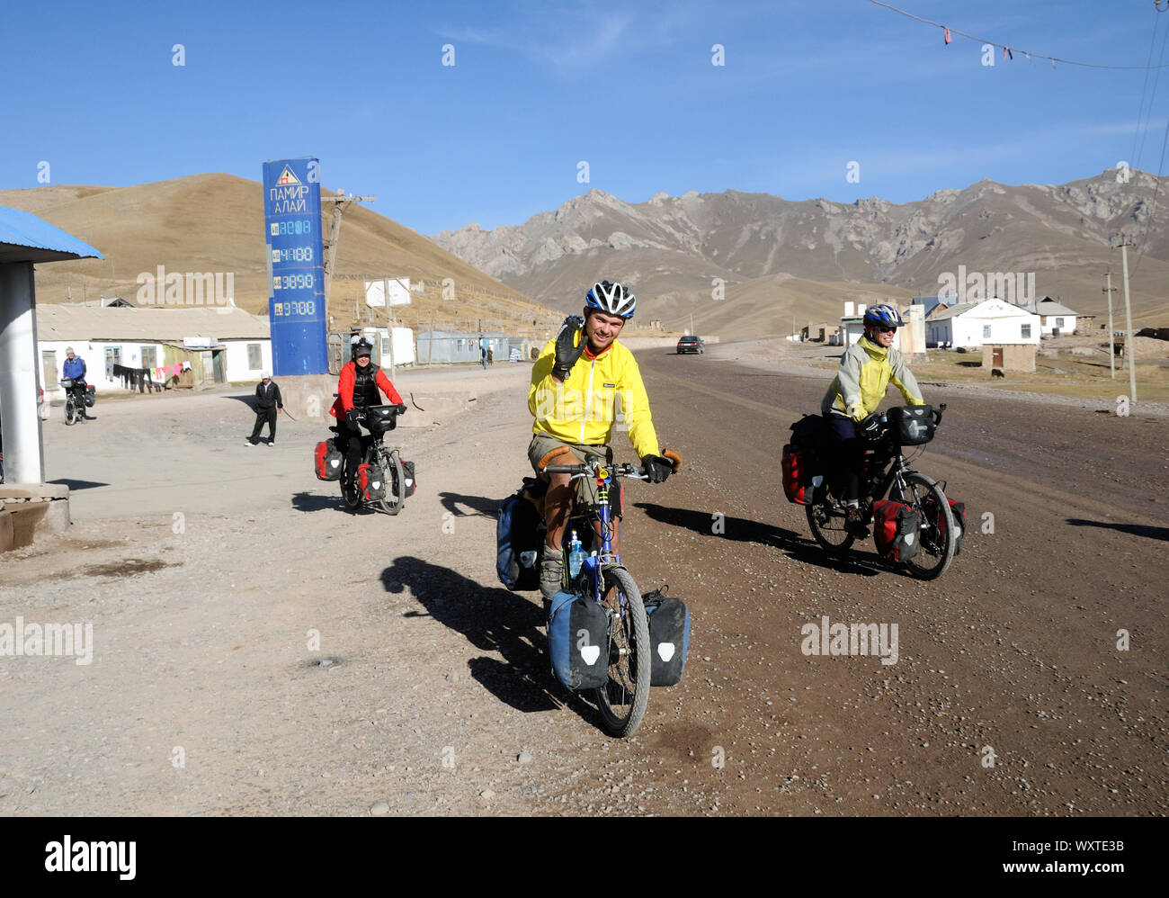A group of Western cyclists on the Pamir Highway prepare to leave Sary ...