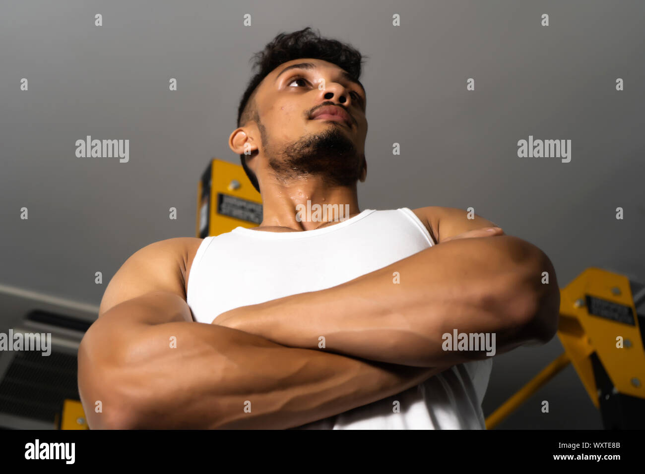 Fit man standing and relax after the training session in gym,Concept healthy and lifestyle,Male taking a break after exercise and workout Stock Photo