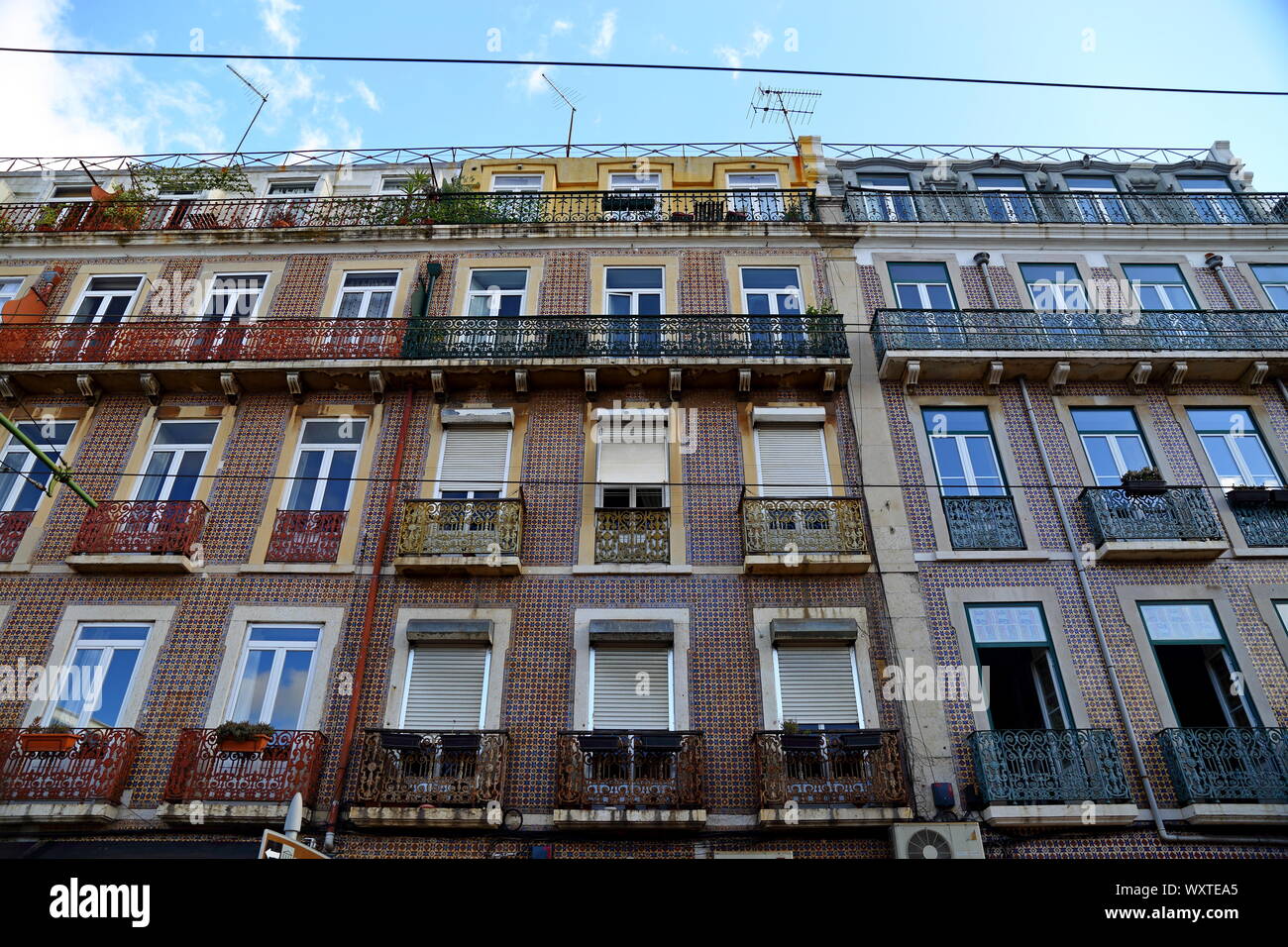Traditional colorful buildings with azulejo tiles facade in the old Lisbon neighborhoods Portugal Stock Photo