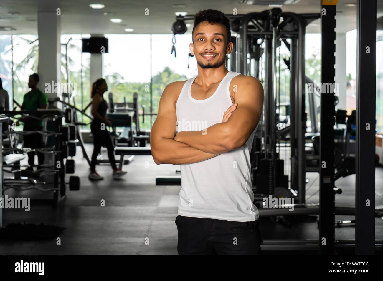 Fit man standing and relax after the training session in gym,Concept healthy and lifestyle,Male taking a break after exercise and workout Stock Photo