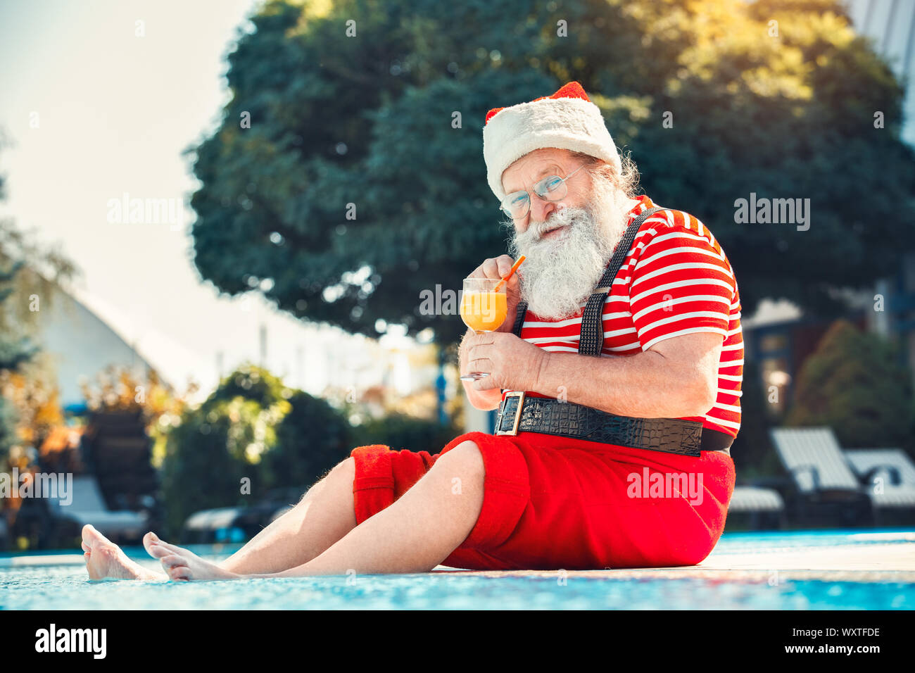 Santa Claus near the pool holiday vacation concept Stock Photo