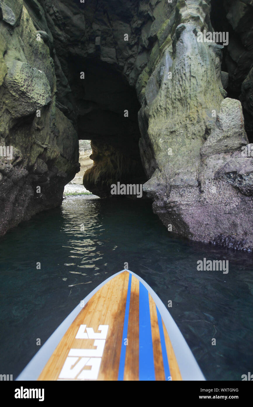 San Diego, California, USA. 24th May, 2010. A stand up paddle board heads into a cave in La Jolla Cove on a warm summer day. The cove is protected as part of a marine reserve, which is rich in marine life, and is popular with kayakers, snorkelers, swimmers and scuba divers. Credit: KC Alfred/ZUMA Wire/Alamy Live News Stock Photo