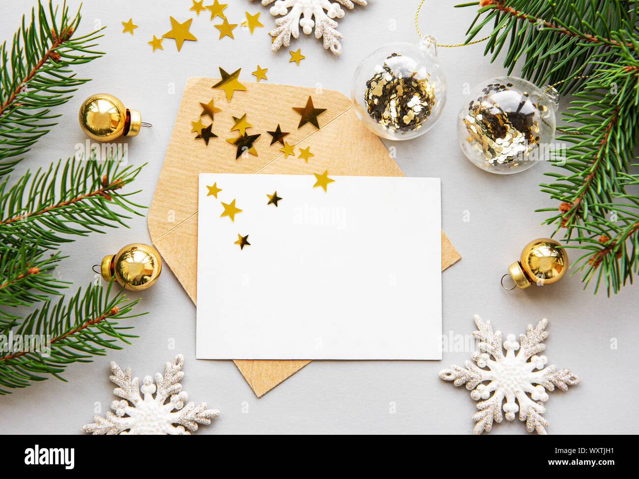 Christmas greeting card with fir tree branches and decorations over ...