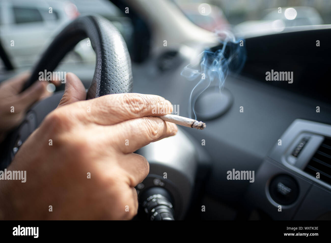 Hanover, Germany. 15th Sep, 2019. Illustration A man sits smoking at
