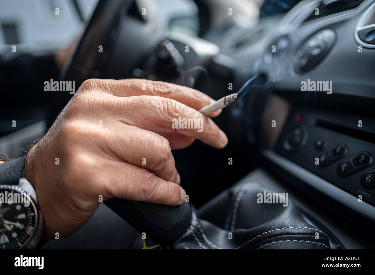 Hanover, Germany. 15th Sep, 2019. Illustration A man sits smoking at