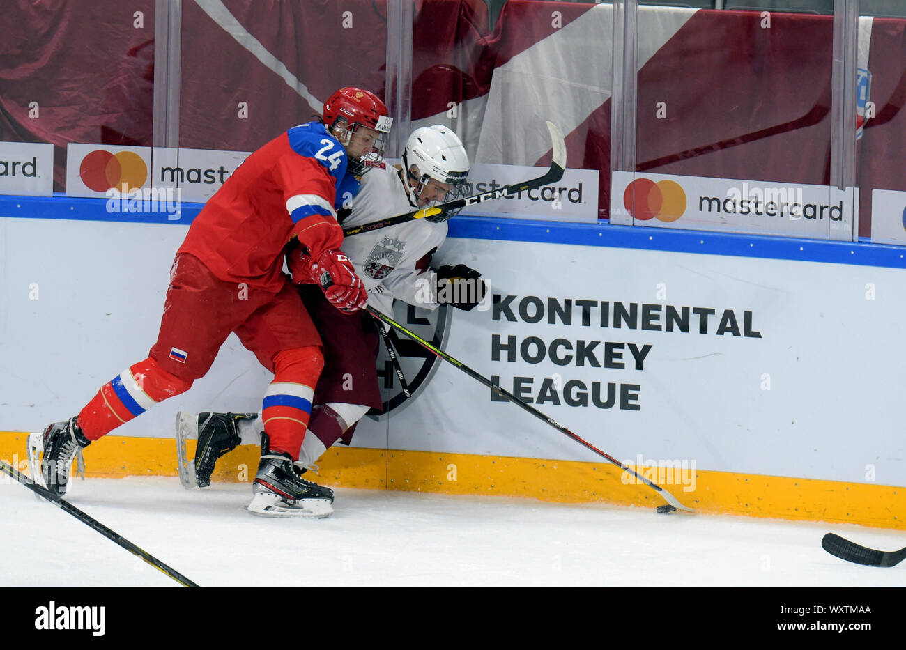 Latvia, Latvia. 17th Sep, 2019. Deniss Vilmans (R) of Latvia vies with Timur Akhunov of Russia during the exhibition match between U-18 national ice hockey teams of Latvia and Russia in Riga, Latvia, Sept. 17, 2019. Credit: Edijs Palens/Xinhua Stock Photo