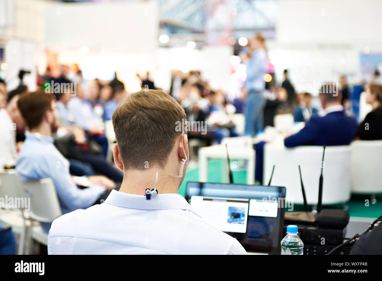 Technician with earphone for servicing seminar events Stock Photo - Alamy