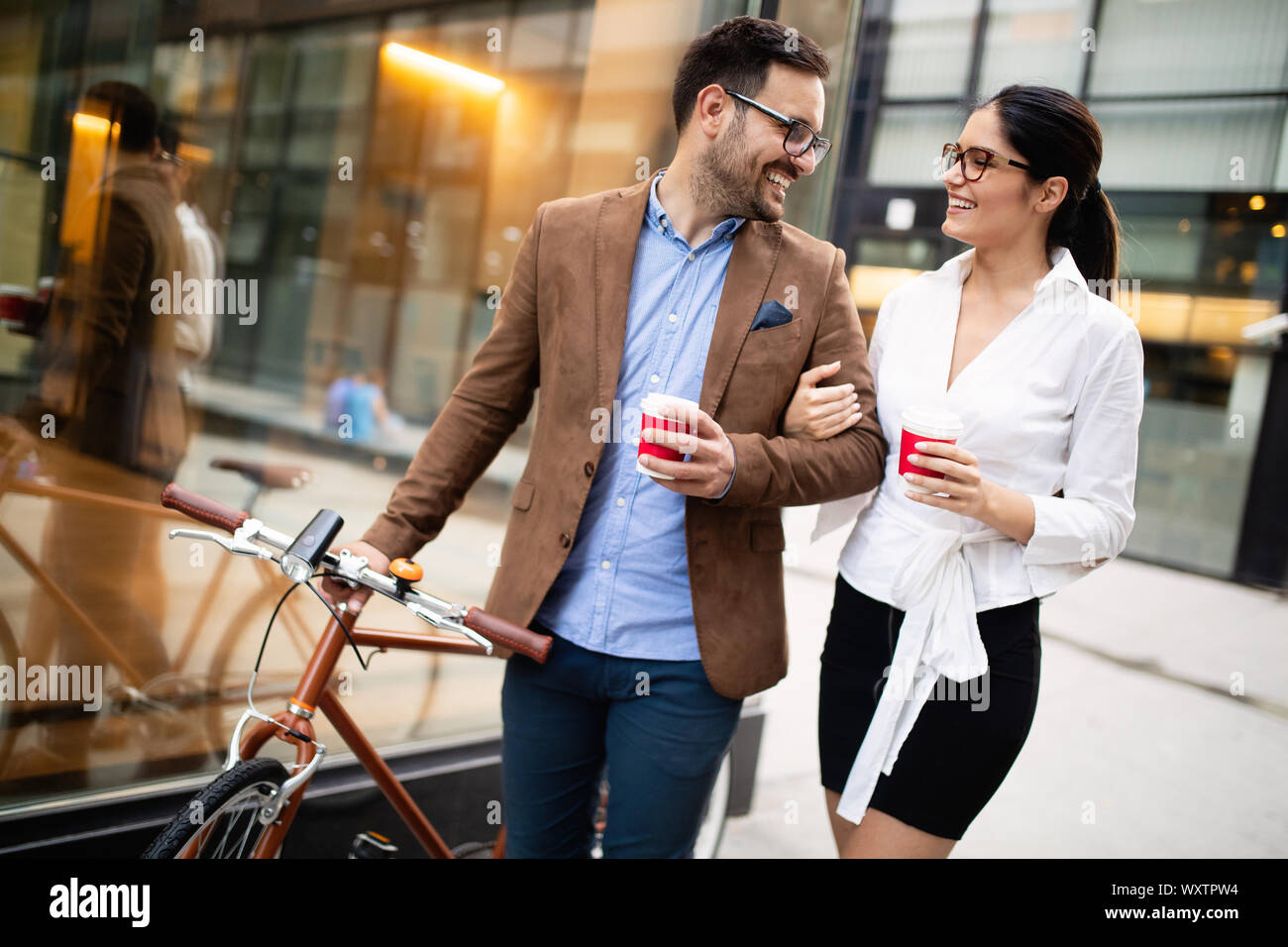 View at young business people talking and smiling outdoors Stock Photo ...