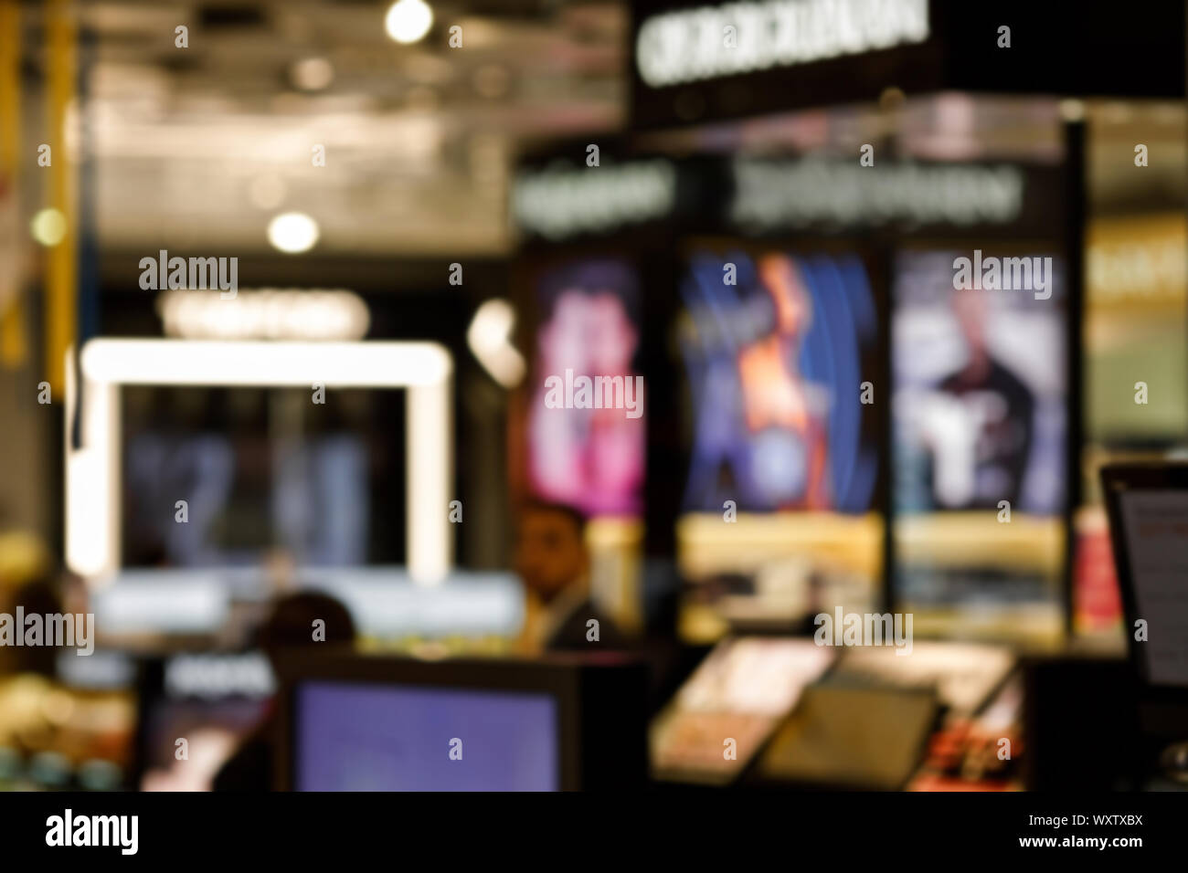 blurred photo of cosmetic shop counter at department stores. beauty stores with variety of prestige and mass cosmetics products Stock Photo