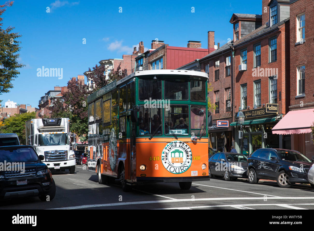 Old Town Trolley Tours in Charles Street in the Beacon Hill historic district of city of Boston, Massachusetts, USA Stock Photo