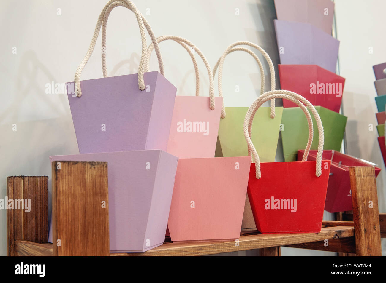 Colorful paper baskets for wrapping gifts and flowers on the shelves of