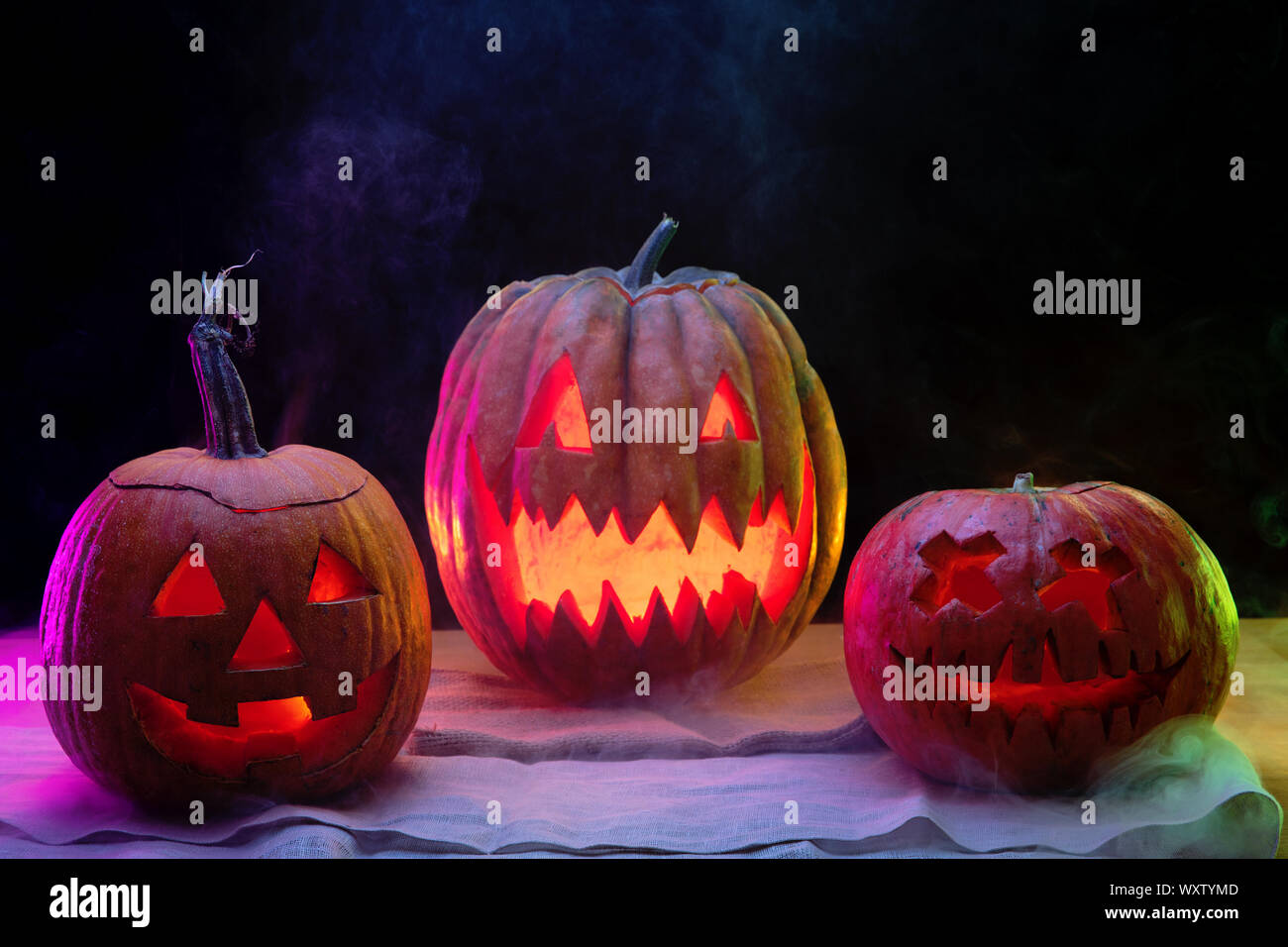 Halloween pumpkin head jack-o-lantern with scary evil faces and candles ...