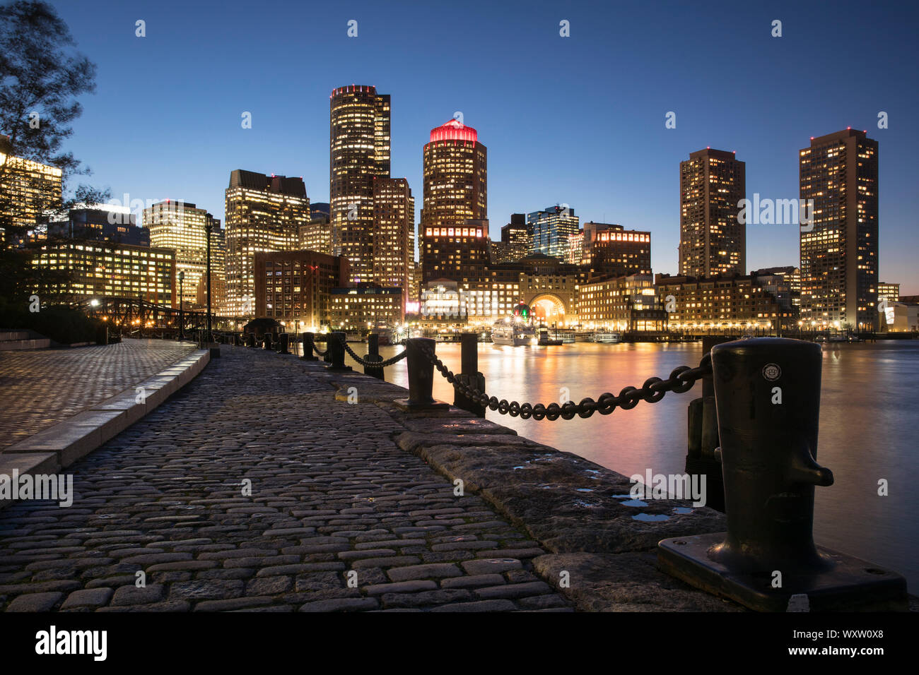 Cityscape of skyscrapers and high rise buildings of city of Boston, Massachusetts at night, USA Stock Photo