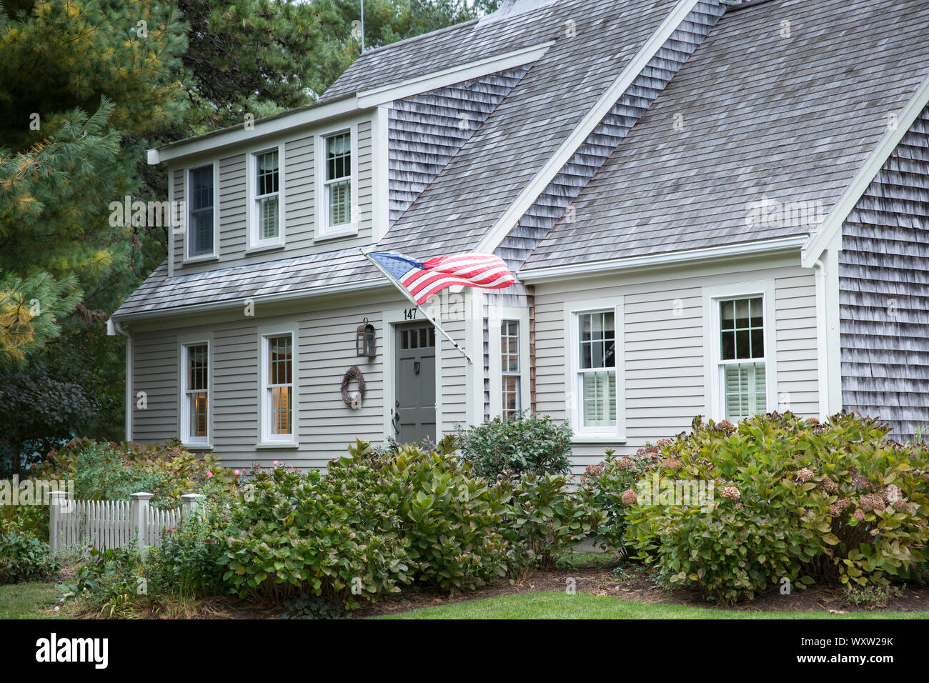 American Flag Flying And Traditional Wooden Timber Clapboard Architecture House Near Cockle Cove At Chatham Cape Cod New England Usa Stock Photo Alamy