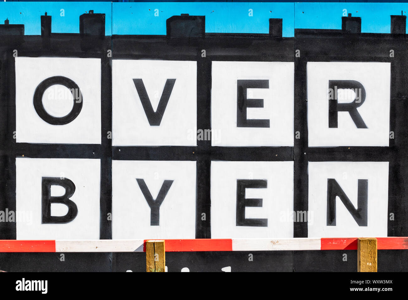 Over Byen Arkitekter (Over Byen Architects), painted sign on building site fence; Copenhagen, Denmark Stock Photo