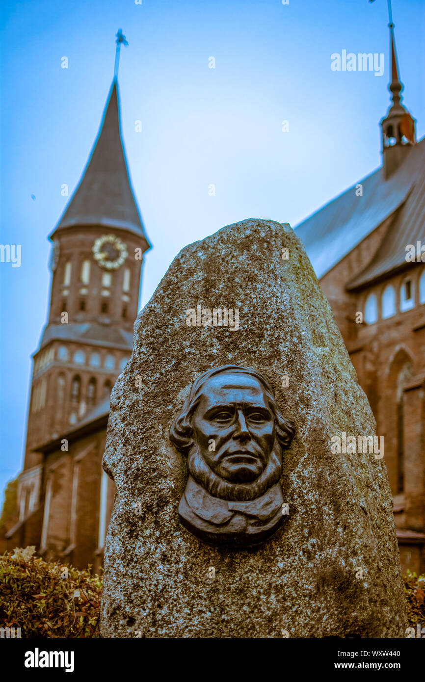 Russia, Kaliningrad, 05.11.2018: The gravestone on the grave of Immanuel Kant on the background of the Cathedral in Kenigsberg. Stock Photo