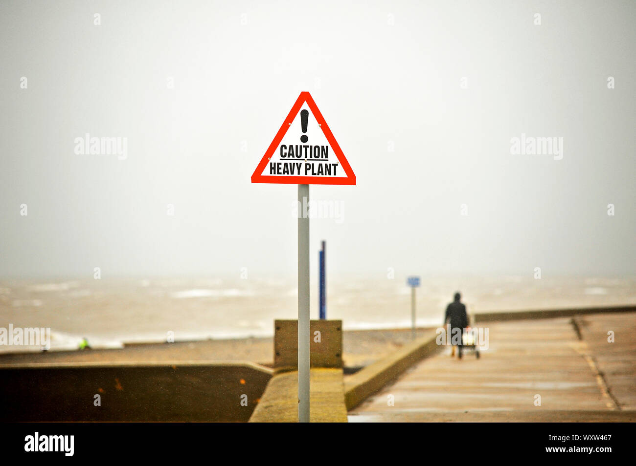 Angler on way home from a wet and windy Fleetwood beach after a mornings fishing Stock Photo