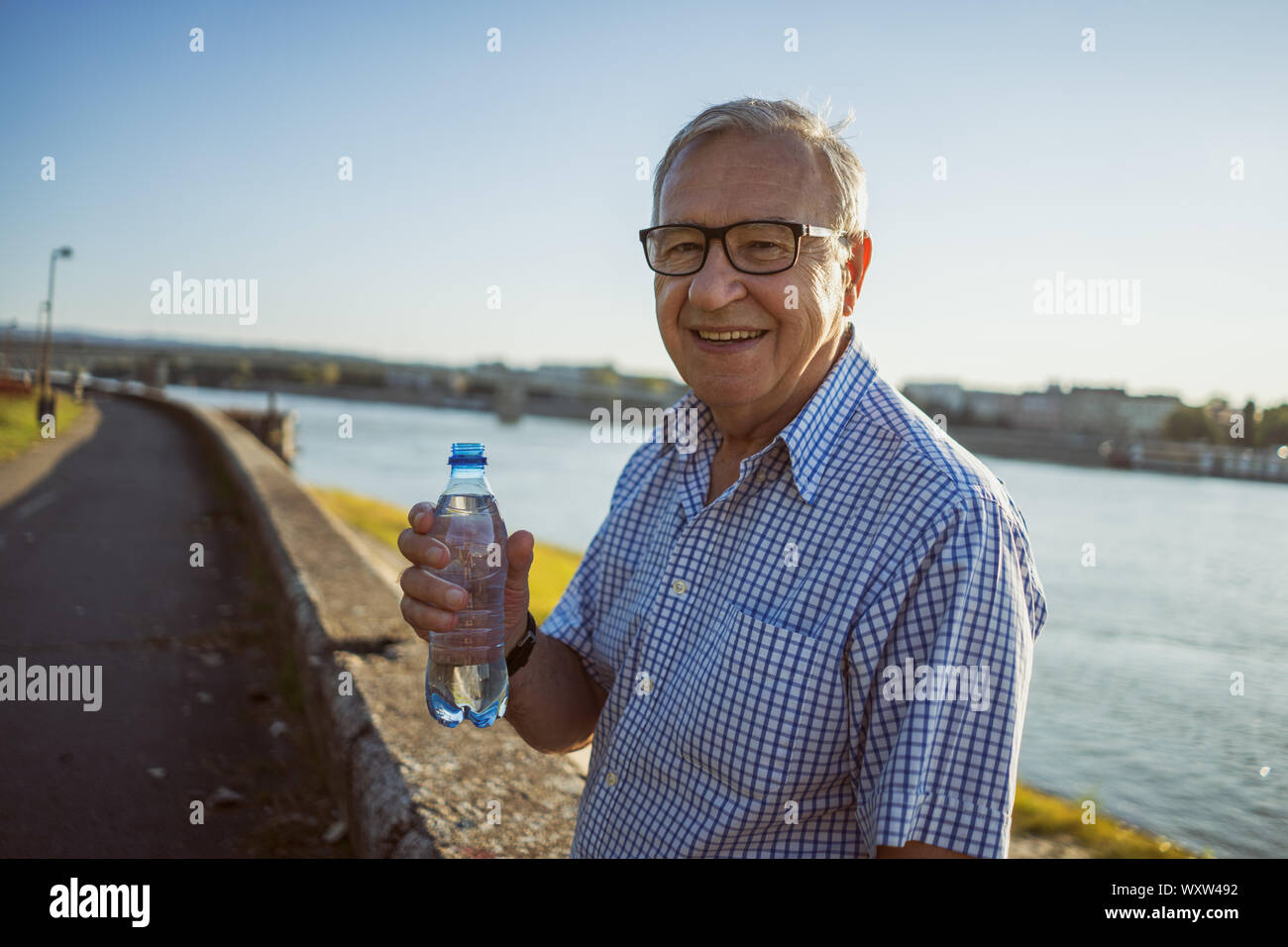 Outdoor portrait of senior man who is holding bottle of water Stock ...