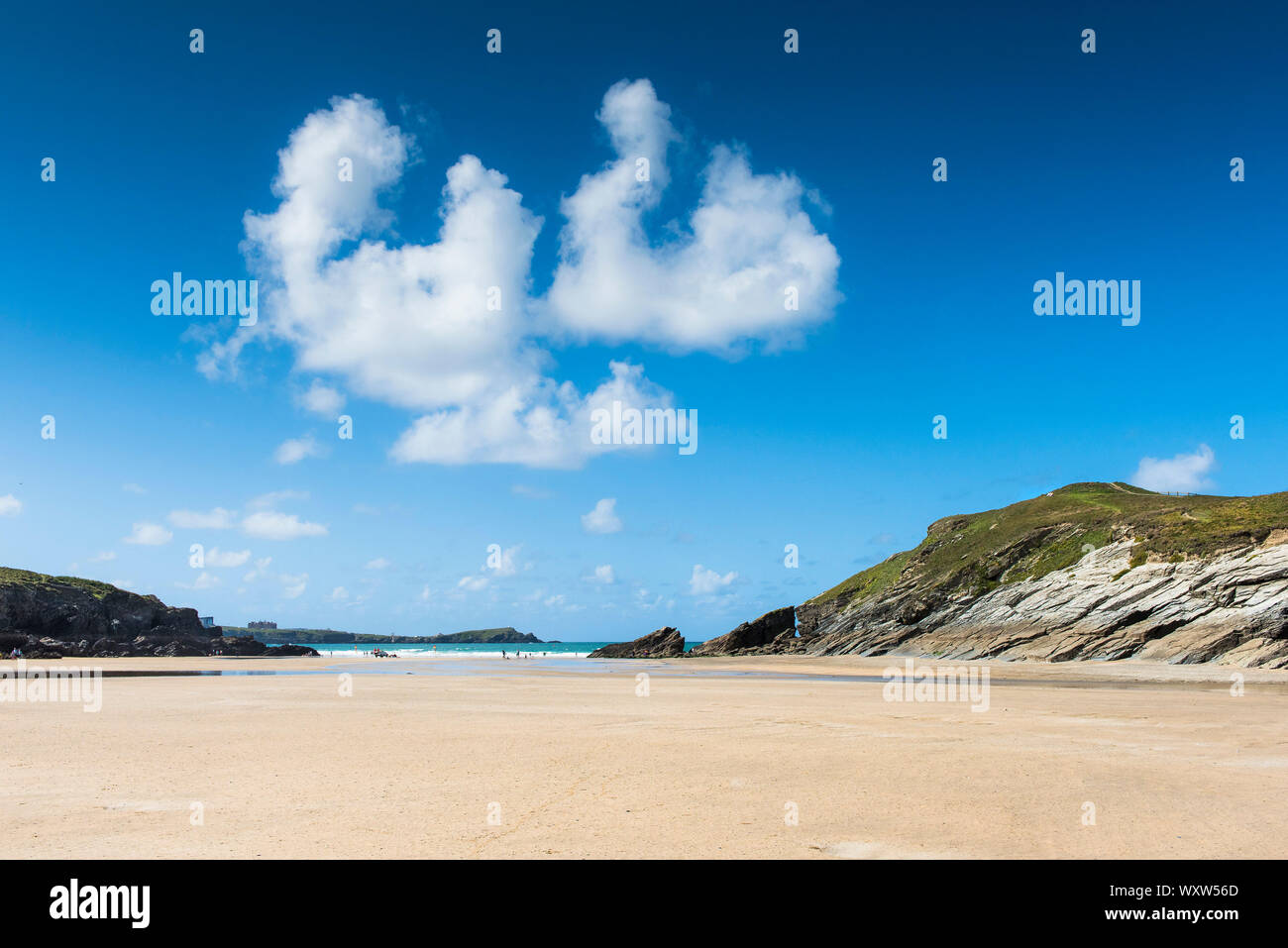 Late Summer sunny weather and a very low tide at Porth Beach in Newquay in Cornwall. Stock Photo