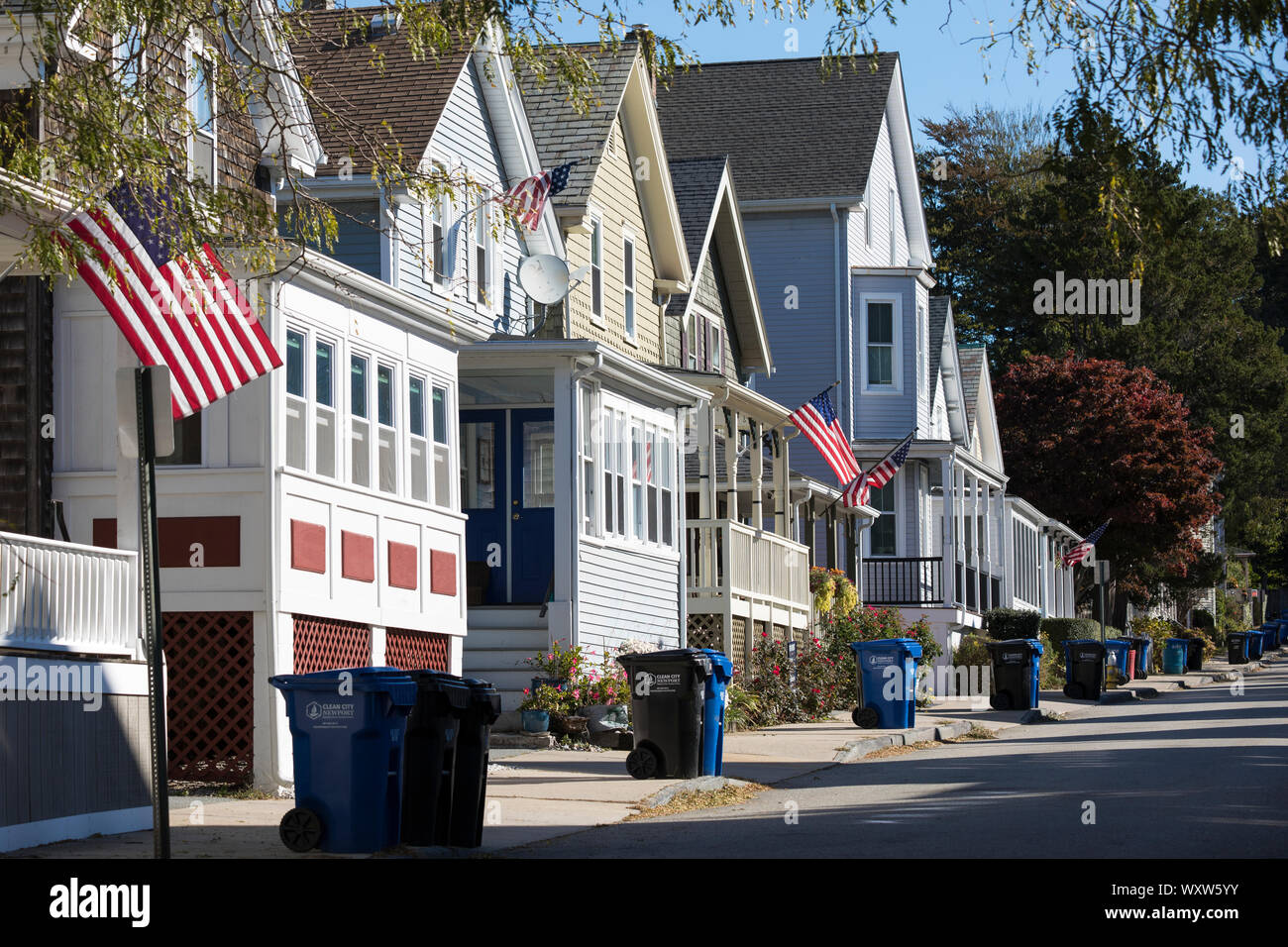 Recycling and general waste plastic wheelie bins awaiting collection