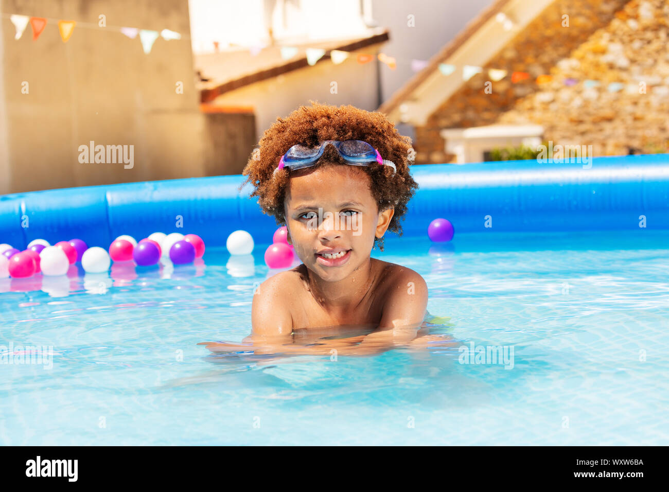 Cute black boy swim in swimming pool water Stock Photo Alamy