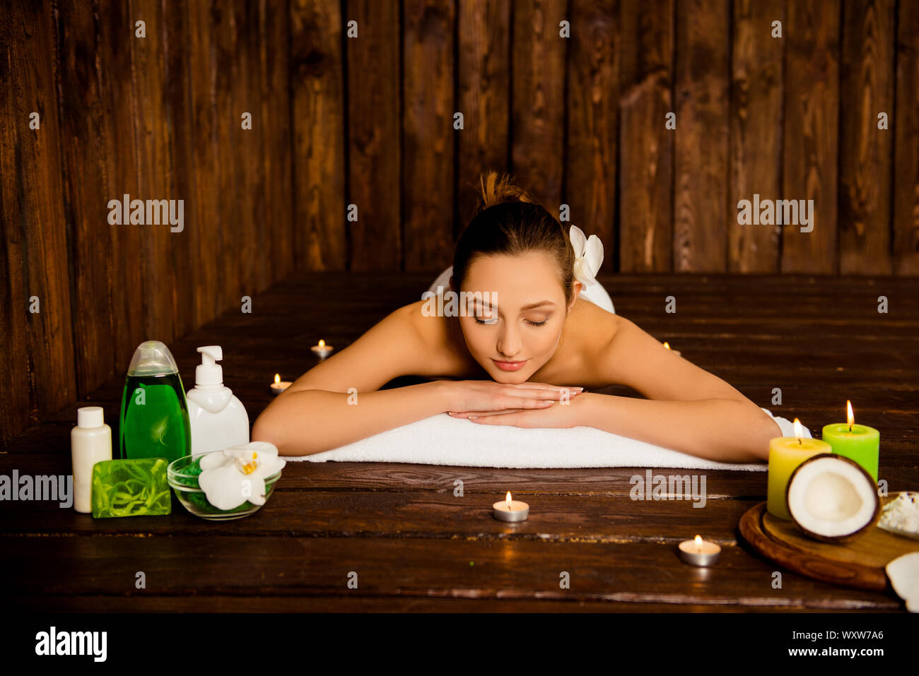 Pretty young woman laying in spa salon with closed eyes and relaxed Stock Photo