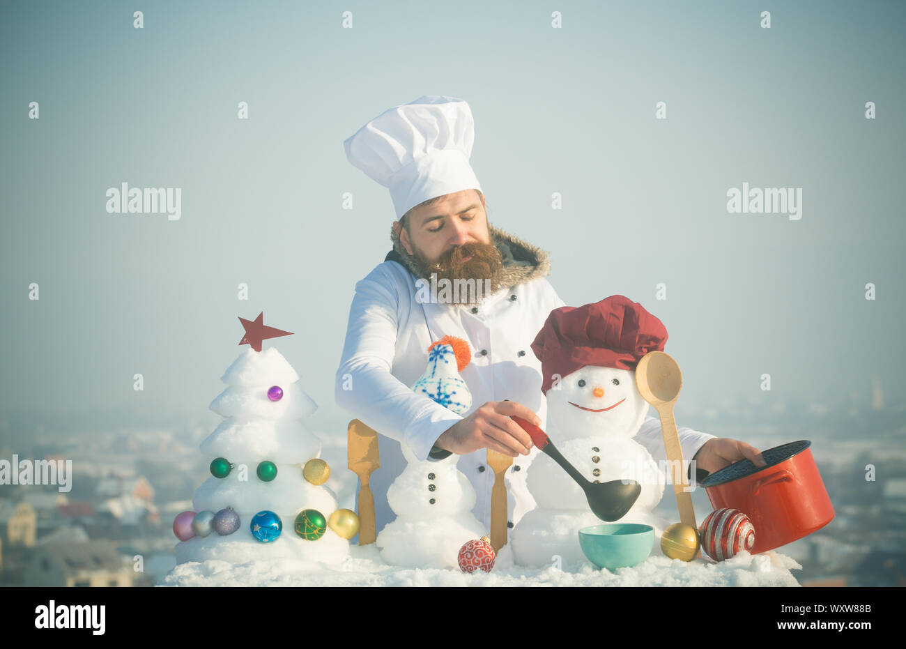 Man in chef hat ladling soup on winter 