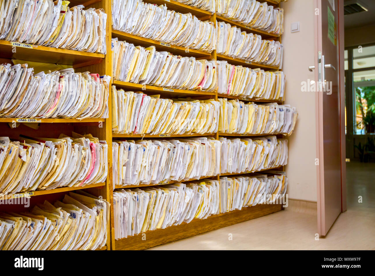 Shelves are full with folders and files of medical record, patient